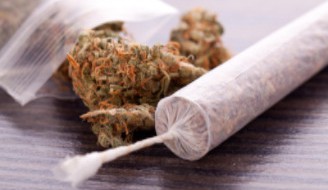 Marijuana joing on table with bag of cannabis: WeedWired Marijuana Legalization Blog